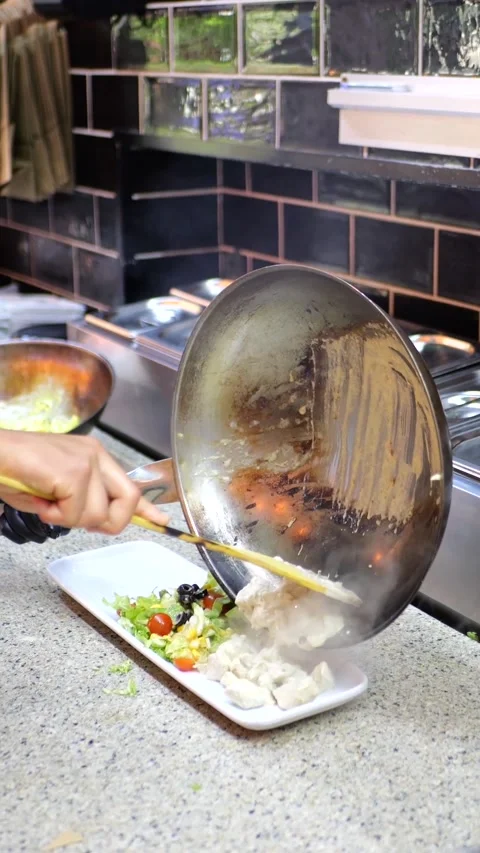 Chef hands shoot pouring penne pasta on a plat in kitchen Vídeos de archivo 312054381