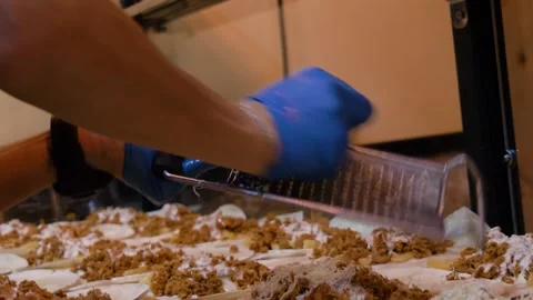 Chef hands shredding cheddar cheese with grater on tacos in slow motion Stock Footage 138749634