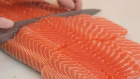 Chef Hands Skillfully Slicing Fresh Raw Salmon Fillet on Board Stock Footage 333489430