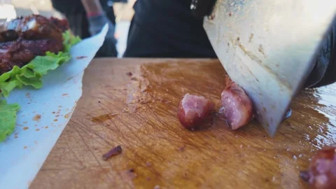 Chef Hands Slicing Grilled Sausage on Wooden Cutting Board During Food Prep.. Stock Footage 341154981