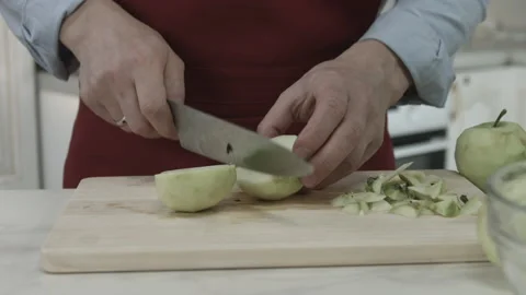 Chef Hands Slicing Peeled Apple with Knife Tool Stock Footage 160977647