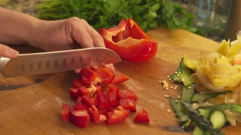 Chef hands slicing a red bell pepper on a wooden cutting board Stock-Footage 331314016