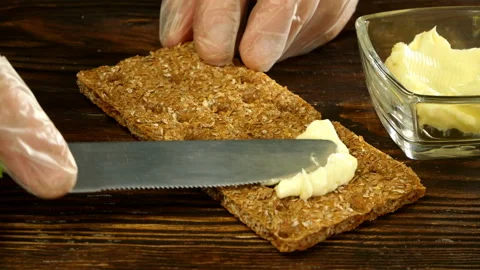 Chef hands spreading butter on crispbread. Stock Footage 133157976