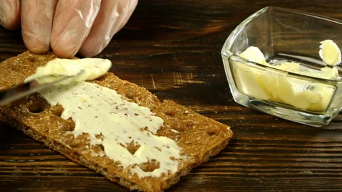 Chef hands spreading butter on crispbread. Stock Footage 133158294