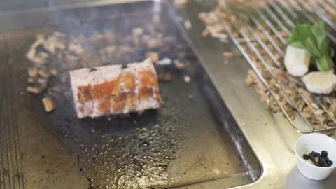 Chef hands sprinkle large salt to meat during cooking. Traditional Italian dish Stock Footage 88672635