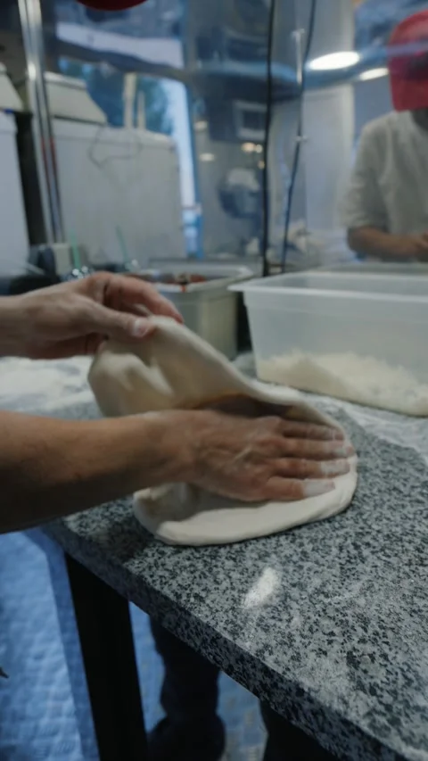 Chef hands stretching pizza dough preparing meal Stock Footage 327465893