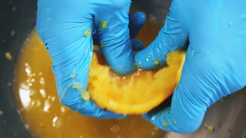 Chef hands top down squeeze orange juice close up Stock Footage 205194272