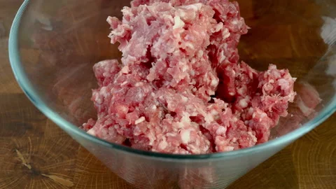 Chef hands in transparent gloves mix minced meat with spices in glass bowl. Stock Footage 234068725