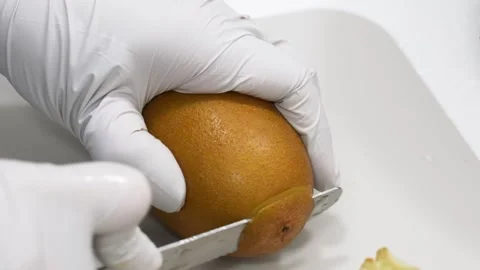 Chef Hands Wearing White Gloves Slicing Fresh Mango for Fruit Dessert Preparatio Stock Footage 343020412