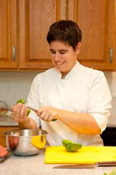 Chef happy while slicing vegetable Stock Photos