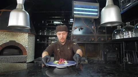 The chef has finished preparing the salad and serves it to the customer. Stock Footage 154890620