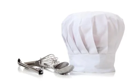 Chef hat and utensils Stock Photos