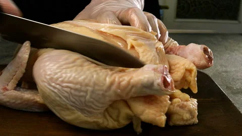 Chef with his hands cuts carcass of raw chicken broiler. Stock Footage 132342837