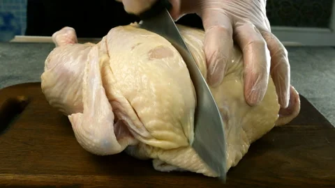 Chef with his hands cuts carcass of raw chicken broiler. Stock Footage 132695502