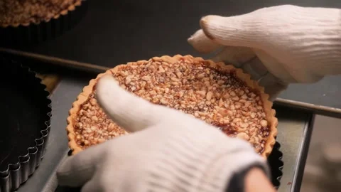 Chef Holding Freshly Baked Walnut Tart with Caramelized Nut Topping Stock Footage 337751500
