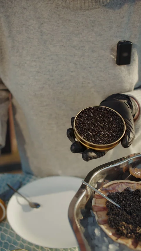 Chef holding open tin of black caviar in gloved hands Stock Footage 309568269