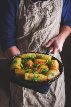 Chef Holding Pan with Cooked Cabbage Rolls Stock Photos