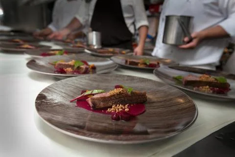 Chef in hotel or restaurant kitchen cooking for dinner Stock Photos