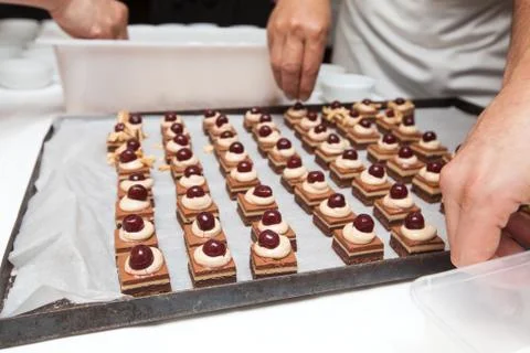 Chef in hotel or restaurant kitchen making dessert for dinner Stock Photos