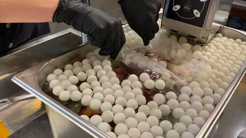 Chef immerses in equipment hermetically packed in a bag of pear soaked in wine Stock Footage 126913182