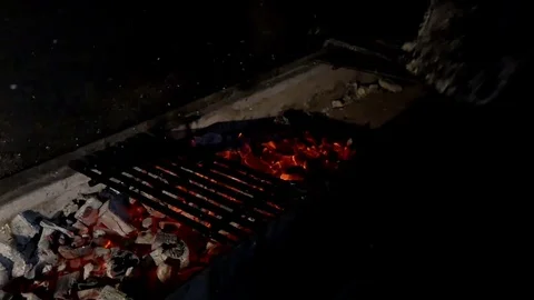 Chef inflates the coals in the grill 스톡 동영상 80041322