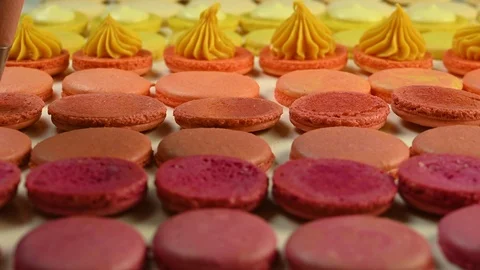 Chef with injector squeezing macaron cream Stock Footage 120400931