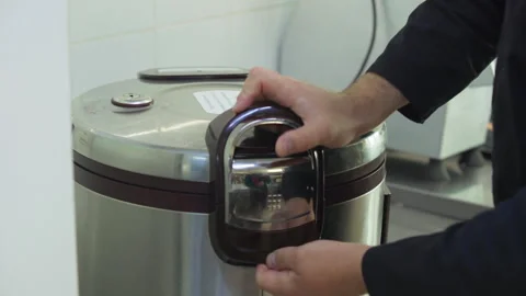 Chef Inserts Pot In Automated Rice Cooker Kitchen Appliance For Food Preparation Stock Footage 309715093