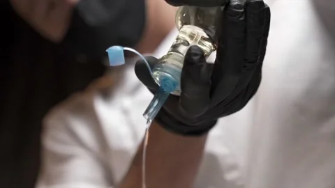 Chef introduces oily liquid into container Stock Footage 168231865