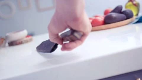 The chef is juggling a knife in the kitchen. Stock Footage 130990305