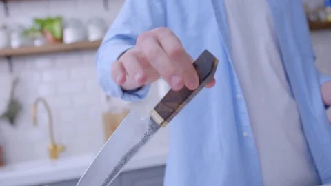 The chef is juggling a knife in the kitchen. Stock Footage 134232012