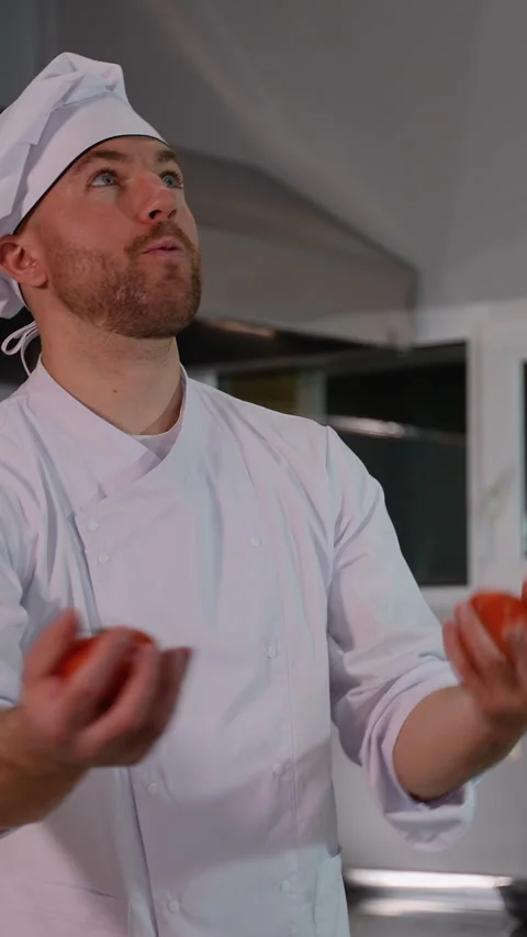 Chef Juggling Tomatoes and Onion in Kitchen Video stock 299664965