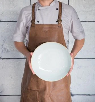 The chef keeps a vertically empty plate Stock Photos