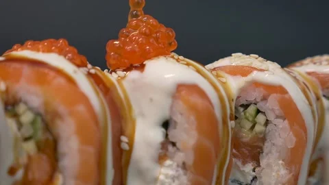 Chef in the kitchen adds caviar to the sushi roll. Asian cuisine Stock Footage 156966962