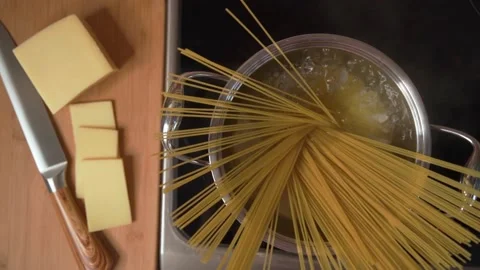 The chef in the kitchen cooks pasta to prepare a delicious dish. Stock Footage 171250412