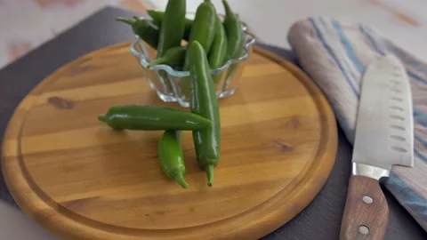 Chef in kitchen mixing and mincing cilantro, red onion, and a jalapeno for Stock Footage 135310396