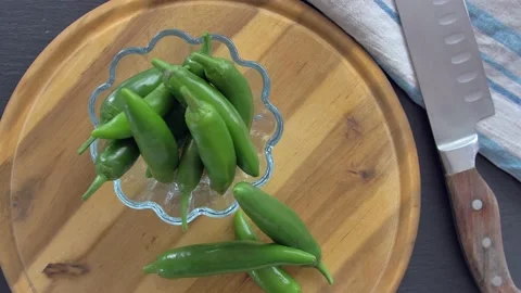 Chef in kitchen mixing and mincing cilantro, red onion, and a jalapeno for Stock Footage 135310457