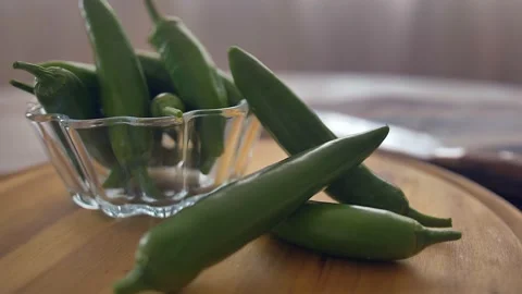 Chef in kitchen mixing and mincing cilantro, red onion, and a jalapeno for Stock Footage 135310482