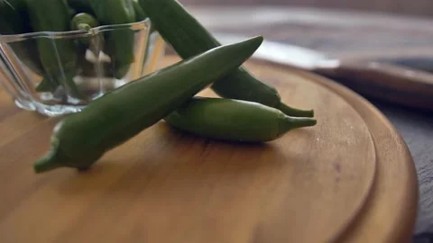 Chef in kitchen mixing and mincing cilantro, red onion, and a jalapeno for Stock Footage 135310559