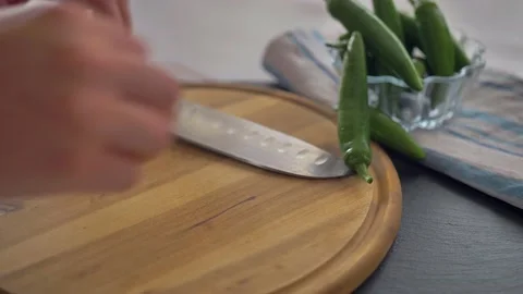 Chef in kitchen mixing and mincing cilantro, red onion, and a jalapeno for Stock Footage 135310672