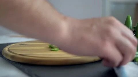 Chef in kitchen mixing and mincing cilantro, red onion, and a jalapeno for Stock Footage 135311049
