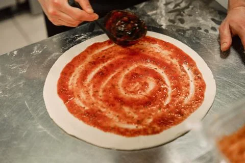 The chef in the kitchen prepares pizza Stock Photos