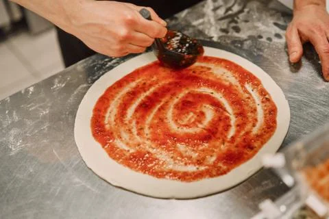 The chef in the kitchen prepares pizza Stock Photos