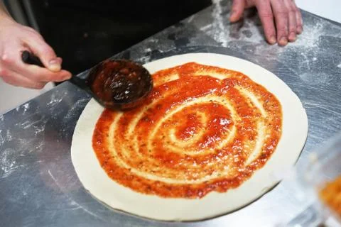 The chef in the kitchen prepares pizza Stock Photos