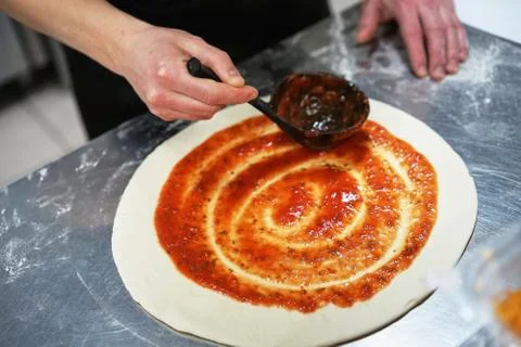 The chef in the kitchen prepares pizza Stock Photos
