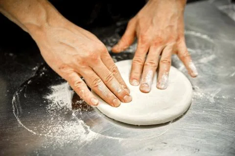 The chef in the kitchen prepares pizza Stock Photos