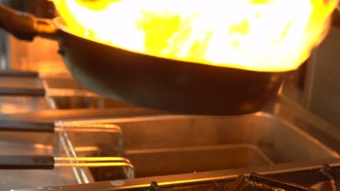 The chef in the kitchen preparing the shrimp, sprinkling them with spices and Stock Footage 103310422