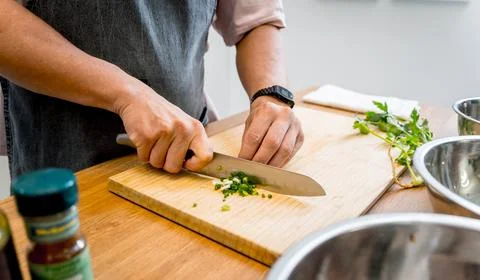 Chef at the kitchen preparing tofu scramble with vegetables Stock Photos