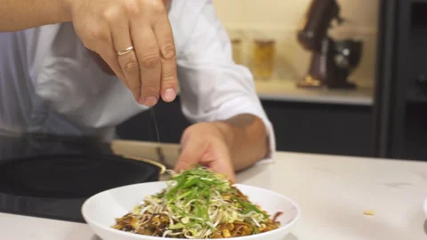 Chef At Kitchen Serves Dish Adding Final Ingredients. Cooking Vegetarian Food. Stock Footage 142818145