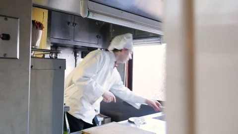 Chef in kitchen vintage pulls water out of cooler on a boxcar train Stock-Footage 117849063