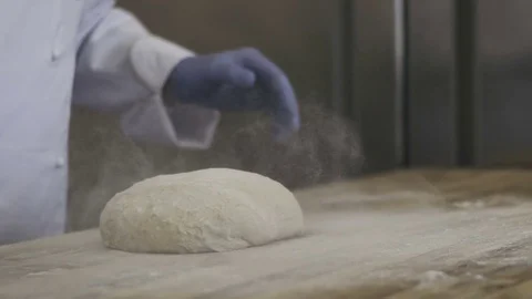 Chef kneading dough in flour on a table Stock Footage